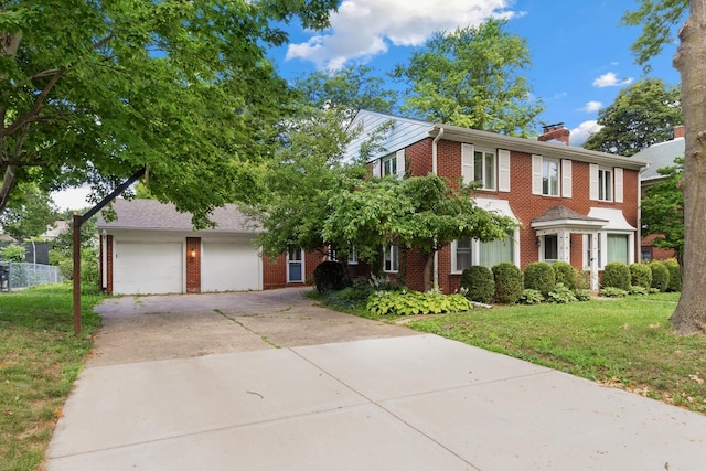 1405 1st Ave, Sterling, IL 61081 - colonial-style house with brick siding, driveway, a chimney, and a front lawn