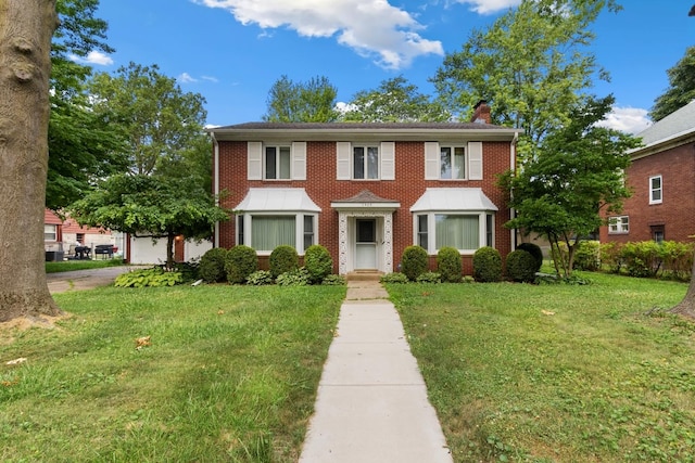 1405 1st Ave, Sterling, IL 61081 - colonial-style house featuring a chimney, a front lawn, and brick siding