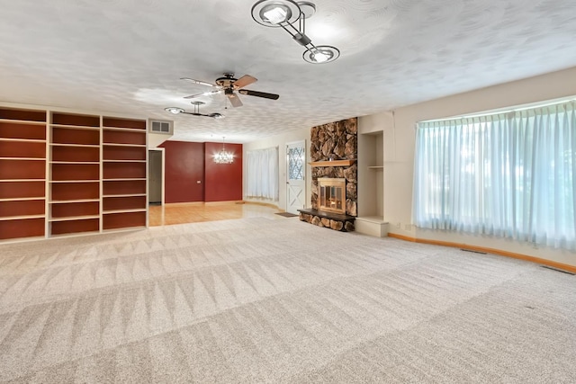 1405 1st Ave, Sterling, IL 61081 - unfurnished living room featuring a chandelier, a ceiling fan, a fireplace, carpet, and a textured ceiling