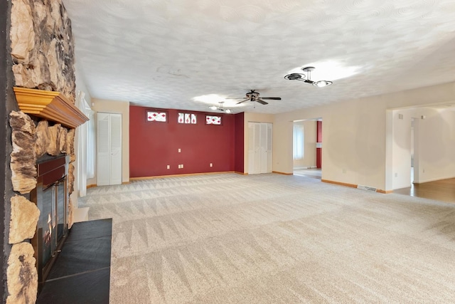 1405 1st Ave, Sterling, IL 61081 - unfurnished living room with light colored carpet, a fireplace, ceiling fan, and a textured ceiling