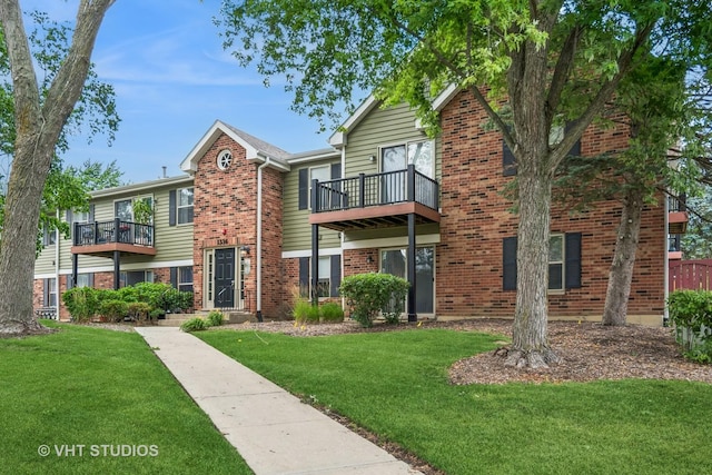 1336 Mcdowell Rd Unit 201, Naperville, IL 60563 - view of front of house featuring a balcony, brick siding, and a front lawn