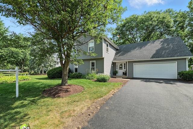 1168 Banbury Cir, Naperville, IL 60540 - view of front of house with an attached garage, asphalt driveway, a front lawn, and a shingled roof