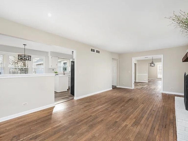 1168 Banbury Cir, Naperville, IL 60540 - unfurnished living room featuring a chandelier and dark wood-style floors