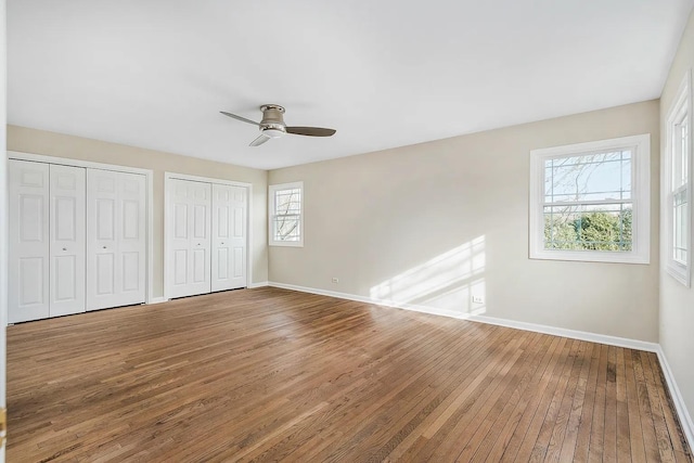 1168 Banbury Cir, Naperville, IL 60540 - unfurnished bedroom featuring hardwood / wood-style flooring, multiple closets, and ceiling fan