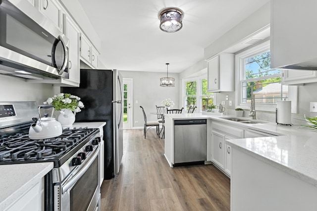 1168 Banbury Cir, Naperville, IL 60540 - kitchen featuring appliances with stainless steel finishes, white cabinets, dark wood-style flooring, and light stone countertops