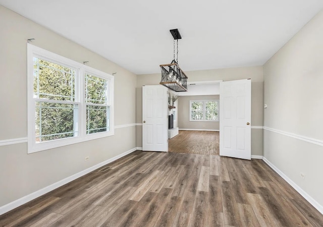1168 Banbury Cir, Naperville, IL 60540 - unfurnished dining area with dark wood finished floors and a chandelier