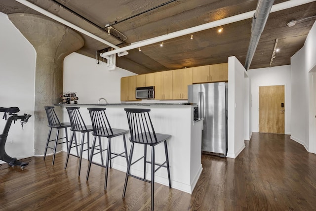 1151 W 14th Pl Unit 238, Chicago, IL 60608 - kitchen featuring black microwave, stainless steel fridge with ice dispenser, light brown cabinetry, dark wood-type flooring, and a kitchen breakfast bar