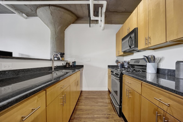 1151 W 14th Pl Unit 238, Chicago, IL 60608 - kitchen with appliances with stainless steel finishes, dark wood-style floors, and dark stone counters