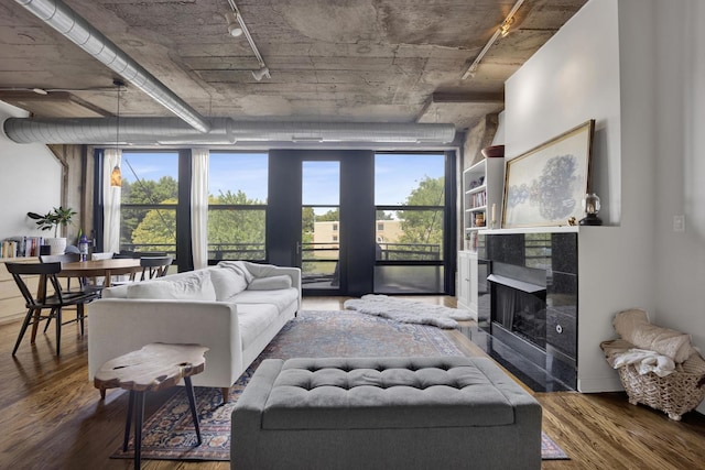 1151 W 14th Pl Unit 238, Chicago, IL 60608 - living room with wood finished floors, rail lighting, and a tile fireplace