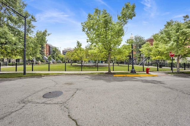 1151 W 14th Pl Unit 238, Chicago, IL 60608 - view of asphalt street with sidewalks, curbs, traffic signs, and street lighting