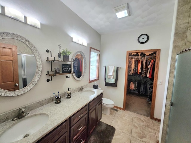 7227 Hawthorne Rdg, Roscoe, IL 61073 - full bathroom with a stall shower, double vanity, tile patterned floors, and a walk in closet