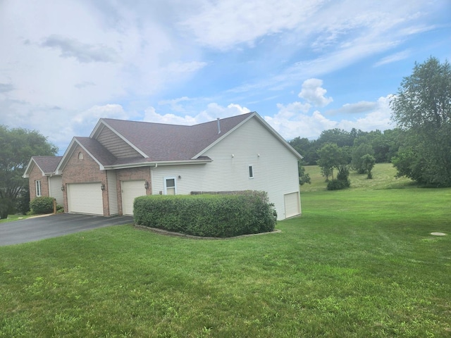 7227 Hawthorne Rdg, Roscoe, IL 61073 - view of side of property featuring asphalt driveway, a garage, a lawn, and a shingled roof