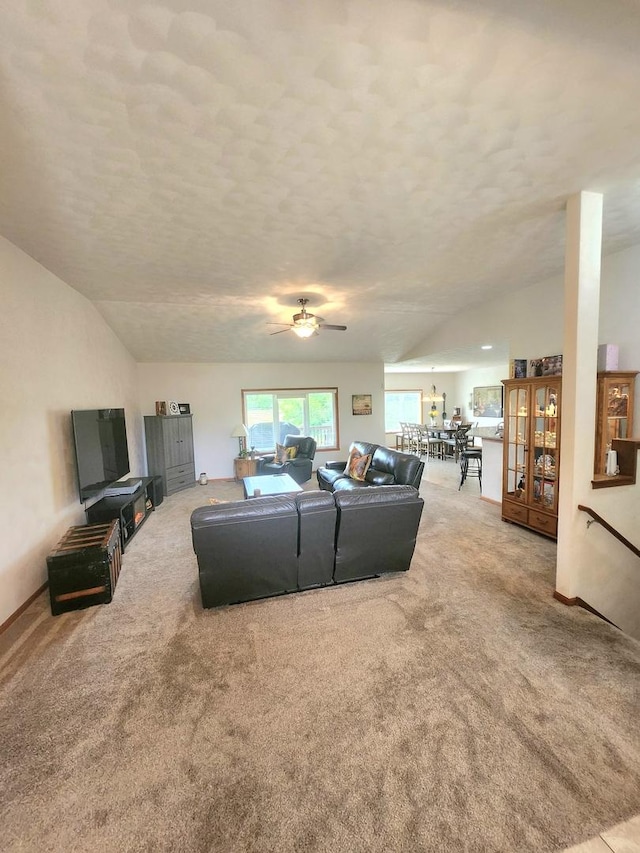 7227 Hawthorne Rdg, Roscoe, IL 61073 - carpeted living area with lofted ceiling, a ceiling fan, and a textured ceiling