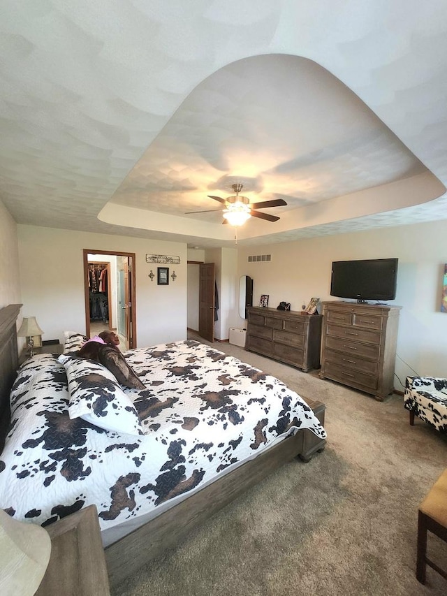 7227 Hawthorne Rdg, Roscoe, IL 61073 - carpeted bedroom with a tray ceiling, a walk in closet, and ceiling fan