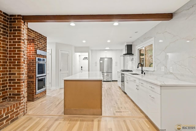 8019 S Malta Rd, Dekalb, IL 60115 - kitchen with wall chimney exhaust hood, appliances with stainless steel finishes, beamed ceiling, light wood-type flooring, and white cabinetry