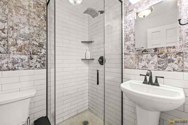 8019 S Malta Rd, Dekalb, IL 60115 - bathroom featuring tile walls, a stall shower, and a wainscoted wall