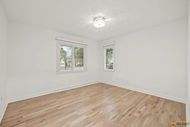 8019 S Malta Rd, Dekalb, IL 60115 - unfurnished room featuring light wood-style flooring and a baseboard radiator