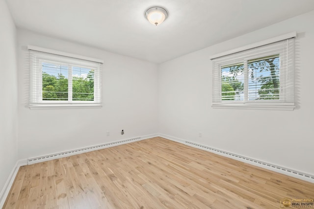 8019 S Malta Rd, Dekalb, IL 60115 - unfurnished room with baseboard heating, healthy amount of natural light, light wood-style flooring, and a baseboard radiator