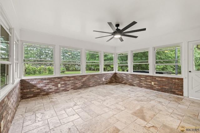 8019 S Malta Rd, Dekalb, IL 60115 - unfurnished sunroom with brick wall and stone tile flooring