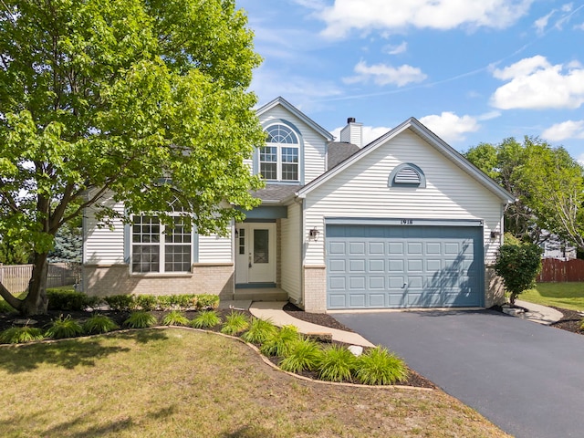 1918 Prairie Ridge Ct, Plainfield, IL 60586 - view of front facade featuring brick siding, asphalt driveway, an attached garage, and a chimney