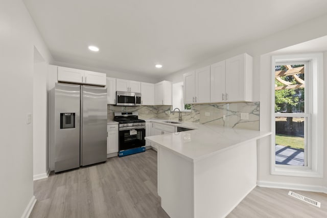 1918 Prairie Ridge Ct, Plainfield, IL 60586 - kitchen with appliances with stainless steel finishes, light wood-style flooring, white cabinetry, and recessed lighting