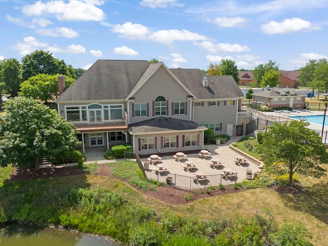 1918 Prairie Ridge Ct, Plainfield, IL 60586 - rear view of house with a patio, a chimney, roof with shingles, and a fenced backyard