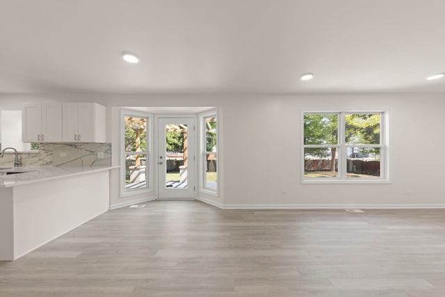 1918 Prairie Ridge Ct, Plainfield, IL 60586 - unfurnished living room with healthy amount of natural light, light wood finished floors, and recessed lighting