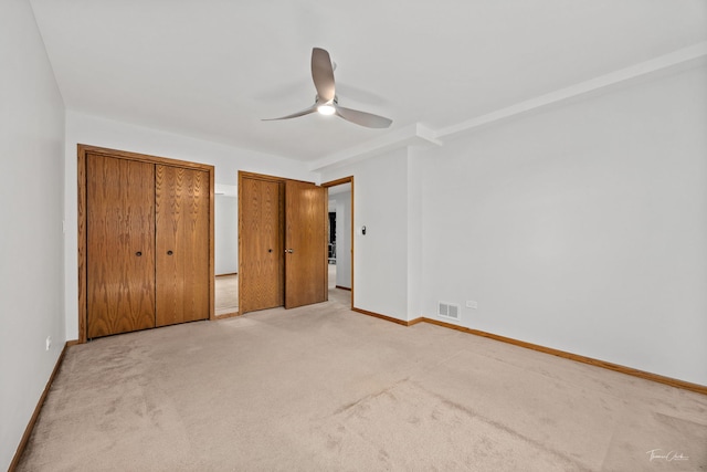 13301 Maverick Trl, Homer Glen, IL 60491 - unfurnished bedroom featuring light colored carpet, two closets, and ceiling fan