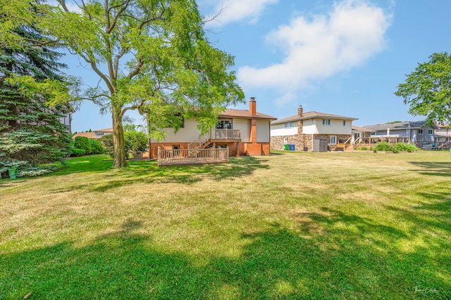 13301 Maverick Trl, Homer Glen, IL 60491 - rear view of house featuring a deck, brick siding, a chimney, and a lawn