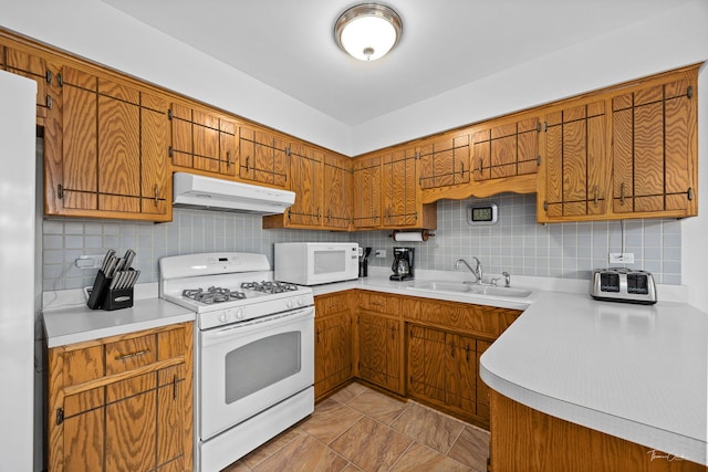 13301 Maverick Trl, Homer Glen, IL 60491 - kitchen with white appliances, under cabinet range hood, light countertops, and tasteful backsplash