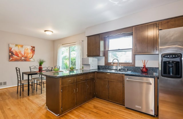 200 Timbercrest Dr, Schaumburg, IL 60193 - kitchen with stainless steel appliances, light wood-style floors, a peninsula, and dark stone counters