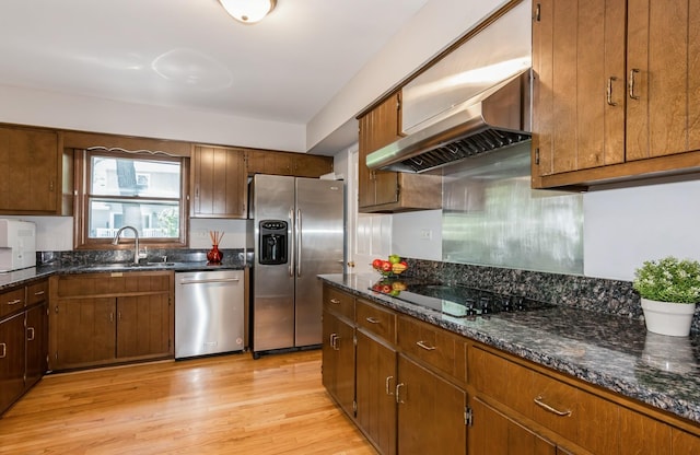 200 Timbercrest Dr, Schaumburg, IL 60193 - kitchen featuring appliances with stainless steel finishes, wall chimney exhaust hood, light wood-type flooring, dark stone counters, and brown cabinets