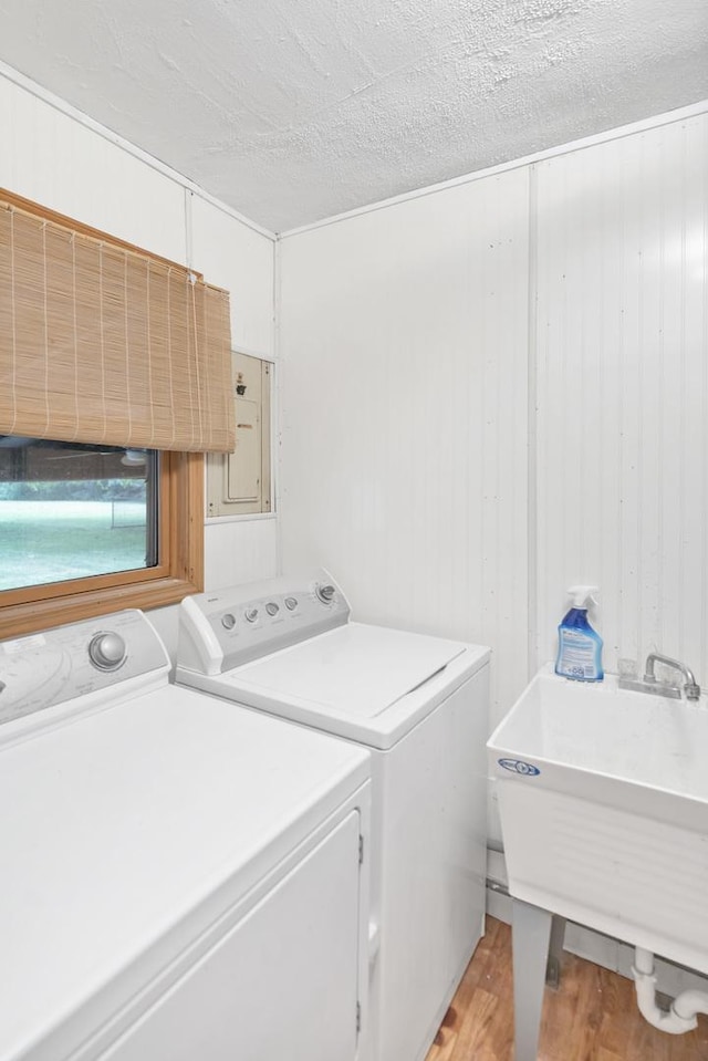 21130 Kildare Ave, Matteson, IL 60443 - washroom featuring separate washer and dryer, light wood-style floors, and a textured ceiling