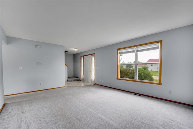 6621 Samantha Ln, Rockford, IL 61107 - carpeted empty room with stairway and baseboards