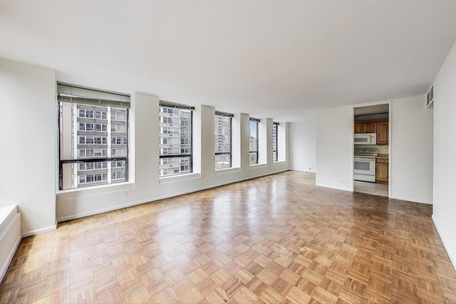 260 E Chestnut St Unit 1904, Chicago, IL 60611 - unfurnished living room featuring baseboards
