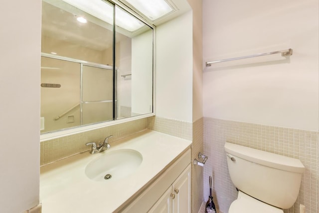 260 E Chestnut St Unit 1904, Chicago, IL 60611 - bathroom featuring vanity, tile walls, and a wainscoted wall