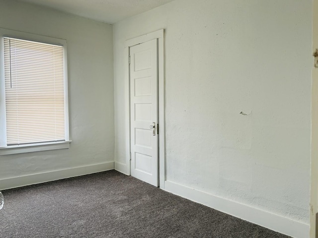 1347 Greenwood Ave, Rockford, IL 61107 - unfurnished room with dark colored carpet and baseboards