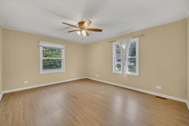 20772 N Elizabeth Ave, Prairie View, IL 60069 - spare room featuring plenty of natural light, ceiling fan, light wood-style flooring, and crown molding