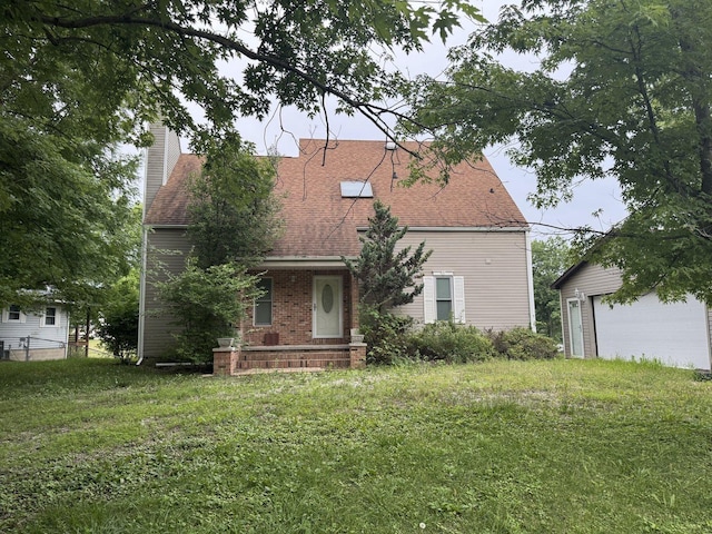 310 Eagle Bluff Dr, Oakwood, IL 61858 - rear view of house with a chimney, roof with shingles, a lawn, a garage, and an outbuilding