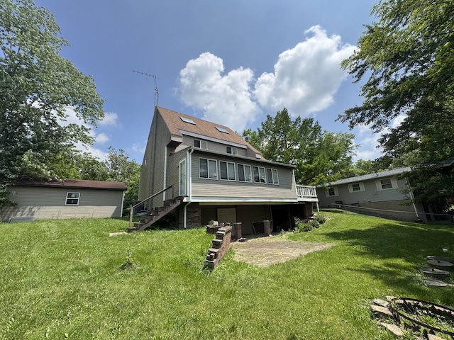 310 Eagle Bluff Dr, Oakwood, IL 61858 - back of property featuring a yard, stairway, and a deck