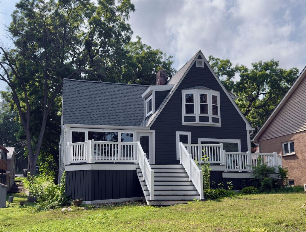5114 W Lake Shore Dr, Wonder Lake, IL 60097 - back of house with stairway, a wooden deck, a lawn, and a chimney