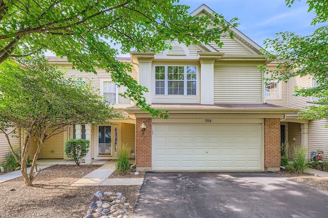 504 Lancaster Dr, Pingree Grove, IL 60140 - traditional-style house featuring a garage, asphalt driveway, and brick siding