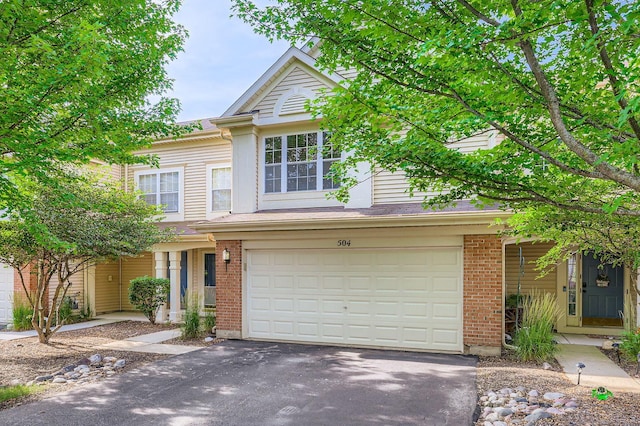 504 Lancaster Dr, Pingree Grove, IL 60140 - traditional-style house with driveway, a garage, and brick siding