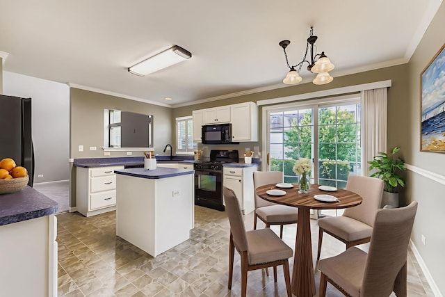 504 Lancaster Dr, Pingree Grove, IL 60140 - kitchen featuring black appliances, dark countertops, white cabinetry, ornamental molding, and a center island