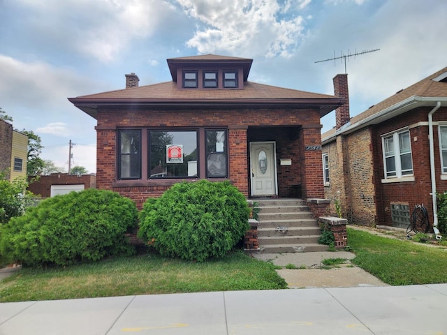 7542 S Prairie Ave, Chicago, IL 60619 - view of front of home with brick siding and a chimney