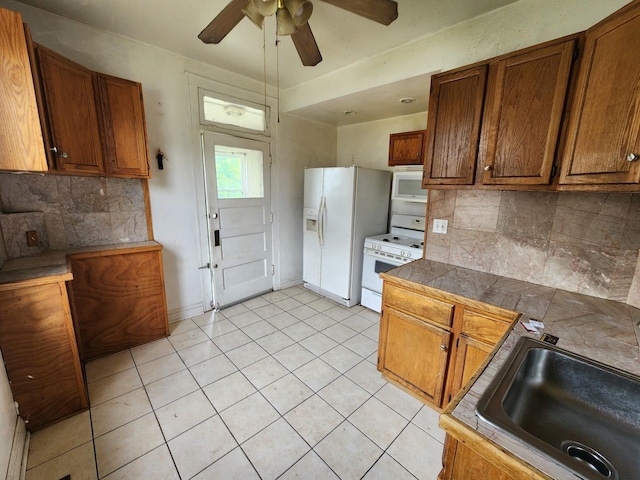 7542 S Prairie Ave, Chicago, IL 60619 - kitchen featuring white appliances, a ceiling fan, and brown cabinets