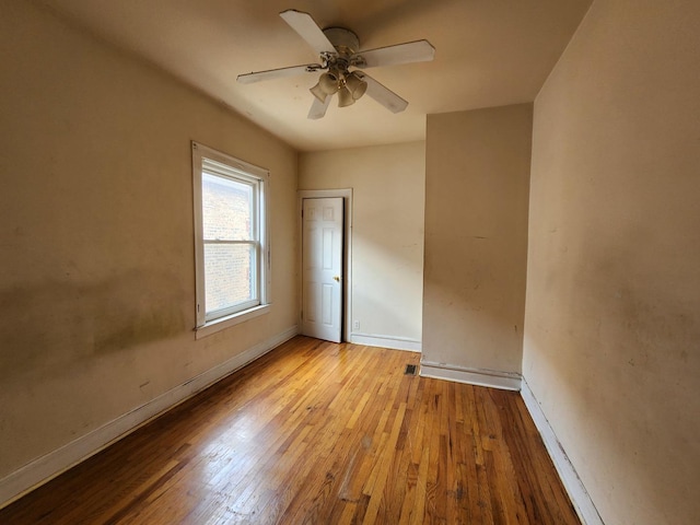 7542 S Prairie Ave, Chicago, IL 60619 - unfurnished bedroom with light wood-style floors and a ceiling fan