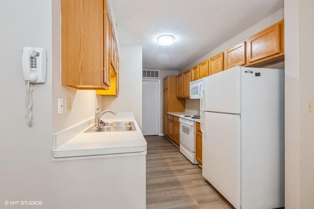 509 Aurora Ave Unit 409, Naperville, IL 60540 - kitchen with white appliances, light countertops, light wood-type flooring, and a textured ceiling