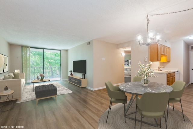509 Aurora Ave Unit 409, Naperville, IL 60540 - dining area with a chandelier, wood finished floors, and floor to ceiling windows