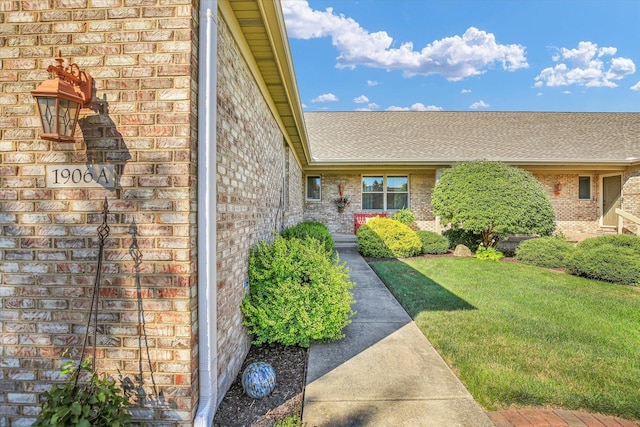 1906 Lydia Ct Unit A, Urbana, IL 61802 - entrance to property featuring brick siding, a lawn, and roof with shingles
